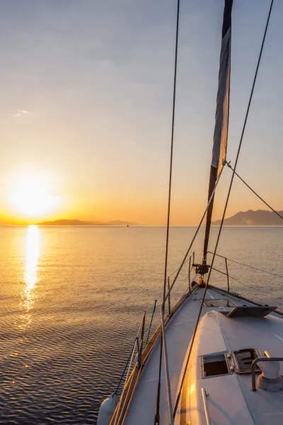 Bow of sailing yacht at sunset