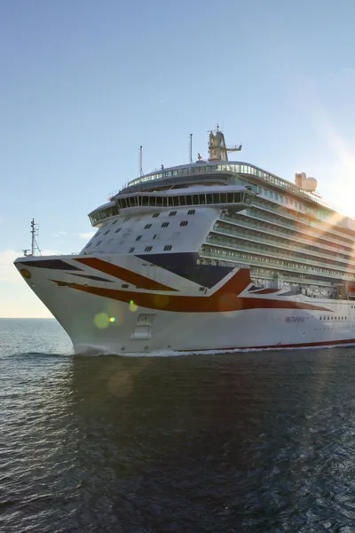 Britannia cruise ship on open waters with blue skies