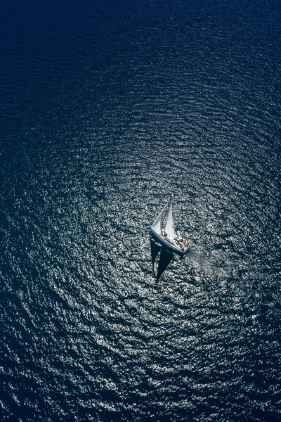 Birdseye view of yacht sailing in the open sea.