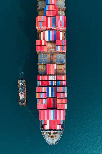 Container ship with tug boat