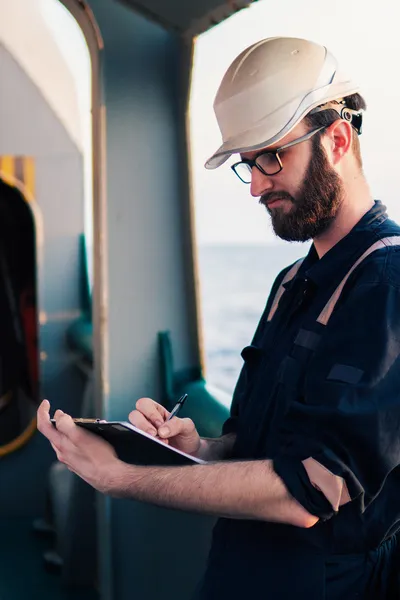 Deck officer filling out paperwork