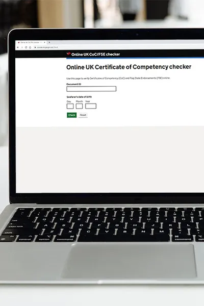 Laptop displaying the Online UK Certificate of Competency checker page on GOV.UK