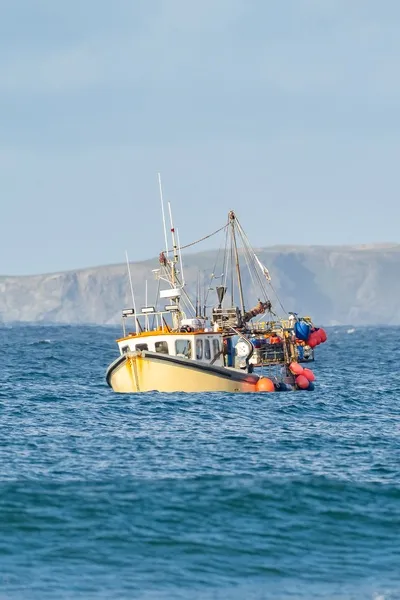 Yellow fishing vessel out at sea