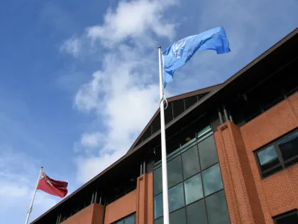 The Red Ensign and International Maritime Organization Flags flying outside the Maritime and Coastguard Agency headquarters