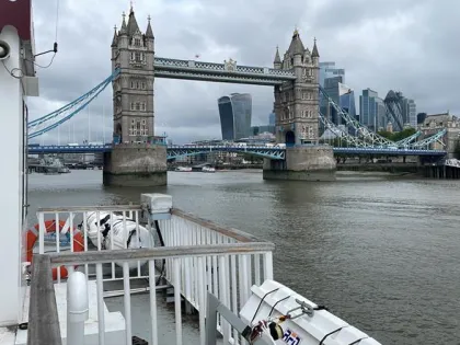 A vessel on the River Thames with Tower Bridge in the view