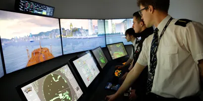 Three cadets training in a simulator