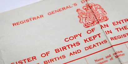 The top of a UK birth certificate, showing the royal crest logo and text that reads' 'births and deaths register'