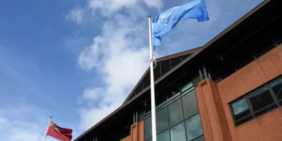 The Red Ensign and International Maritime Organization Flags flying outside the Maritime and Coastguard Agency headquarters