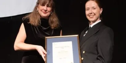 CEO Virginia McVea (left) presents and Luka Haynes with her award