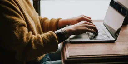 Person typing on laptop