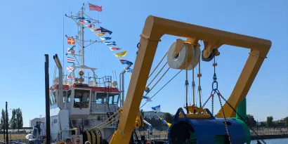 A dredger vessel named Seadragon with flags on the ship including the Red Ensign