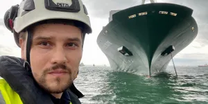 Bart Lubecki, a Senior Surveyor in front of a vessel