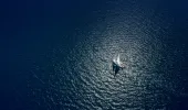 Birdseye view of yacht sailing in the open sea.