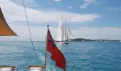 Red Ensign in front of yacht